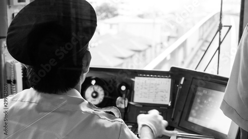 Driver in cockpit of Tokyo subway train, Japan. Black and white.