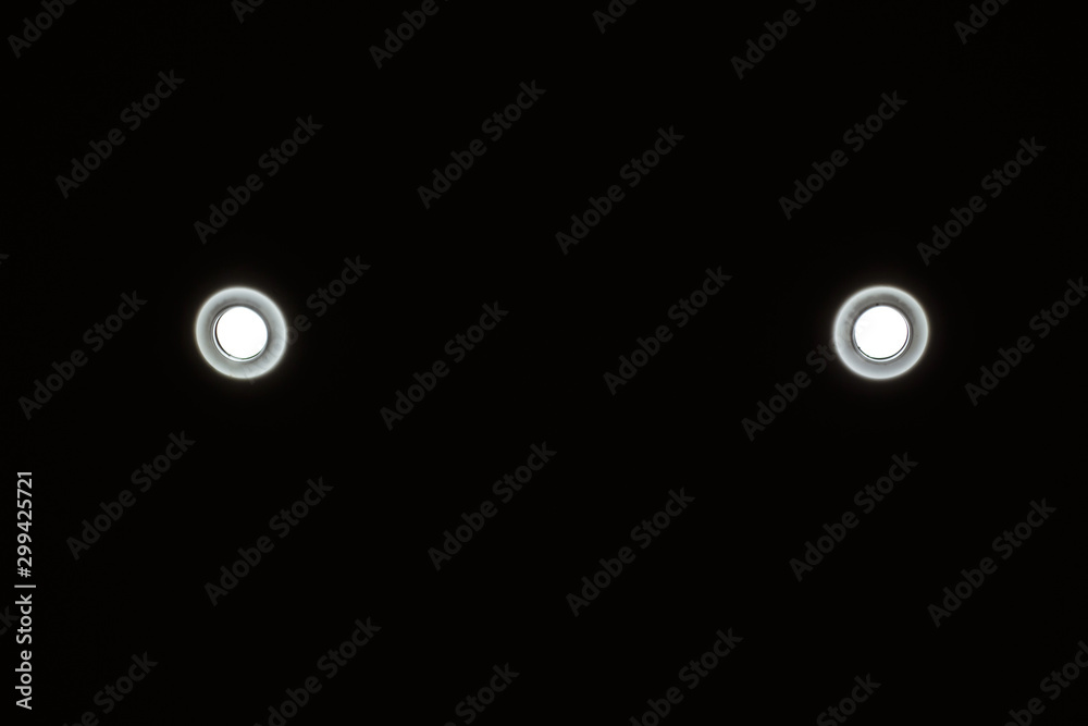 Electric spot fixed to the ceiling, black background. Electric spot fixed to the ceiling, black background.