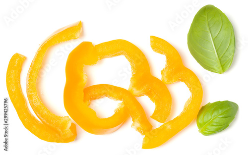 Yellow pepper slices with basil leaves isolated over white background cutout. Top view, flat lay..