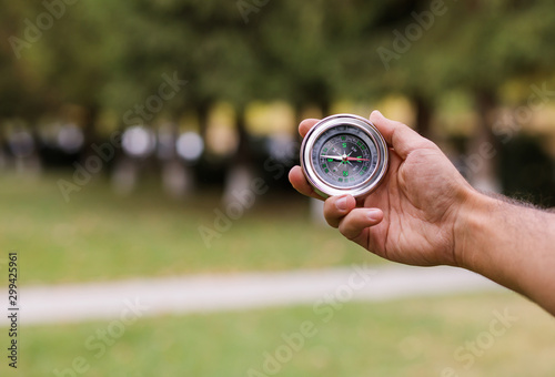 man hand compass in nature