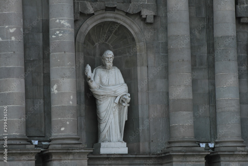 statue of man in front of church
