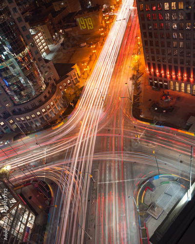 Aerial view of Winnipeg's iconic intersection, Portage and Main at night, with light trails of vehicles passing by