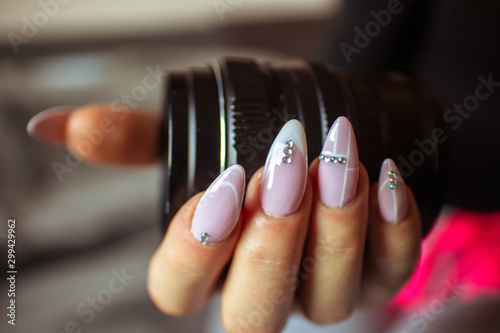Old vintage manual photo lens in women s hands with manicured nails