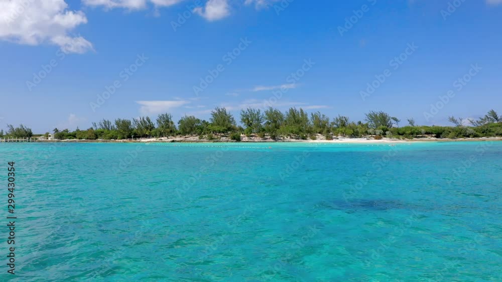 Aerial: Gliding Across Crystal Clear Tropical Water Towards Deserted Island on a Sunny Day - Nassau, Bahamas Aerial: Gliding Across Crystal Clear Tropical Water Towards Deserted Island on a Sunny Day - Nassau, Bahamas