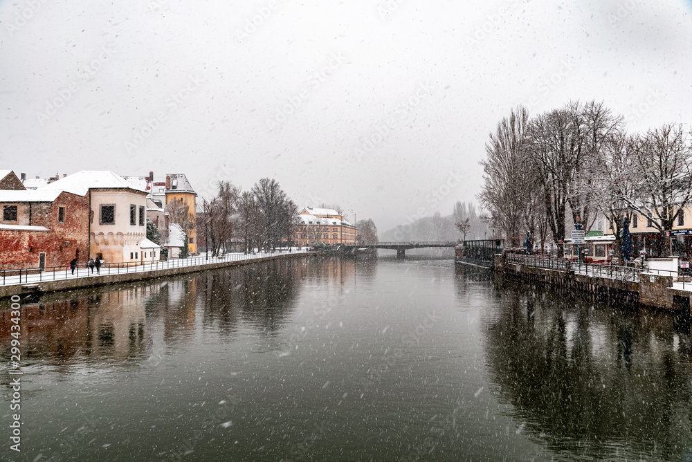 Landshut in winter with snowflakes and reflection
