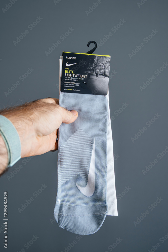 Paris, France - Oct 26, 2019: Man hand holding a pair of new Nike Elite  Over-The-Calf compression socks with Dri-Fit technology - front view Stock  Photo | Adobe Stock