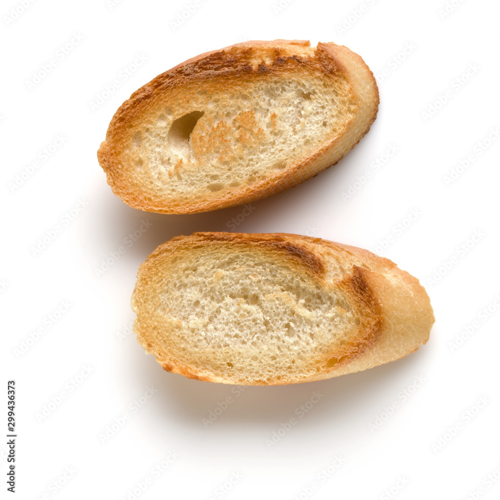 Toasted baguette slices isolated on white background close up. Toast, crouton. Top view. Toasted baguette slices isolated on white background close up. Toast, crouton. Top view.