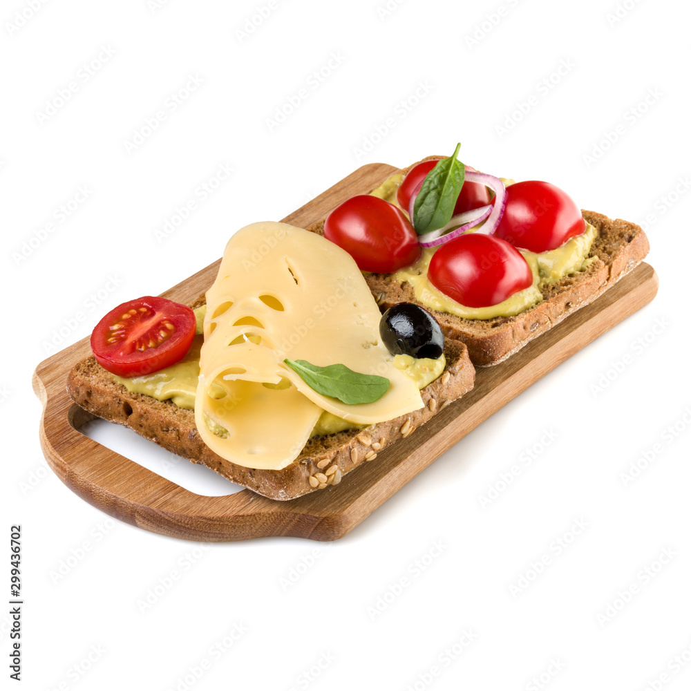 Open  faced vegetable sandwich canape or crostini on a wooden serving board  isolated on white background closeup. Vegetarian tartarine.
