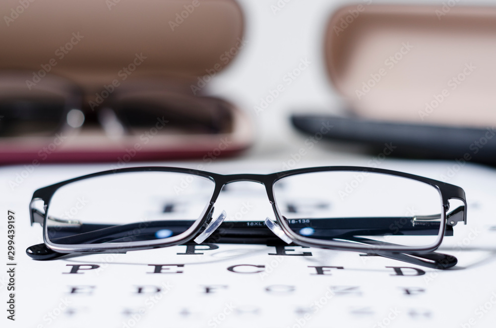 glasses and Eyeglasses on table of check of vision close up - Myopia or hyperopia glasses and Eyeglasses on table of check of vision close up - Myopia or hyperopia