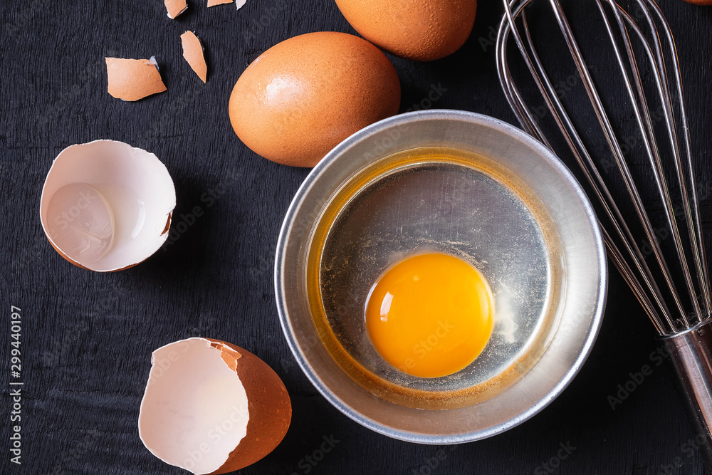 Yolks and egg protein in a cup. Corolla whisk eggs. Preparation of food and chicken eggs Yolks and egg protein in a cup. Corolla whisk eggs. Preparation of food and chicken eggs