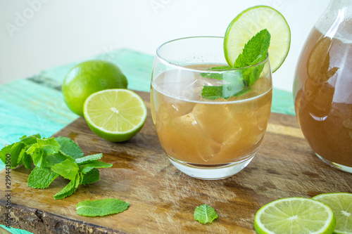 Food photography pf a glass of tamarind water with lime and mint