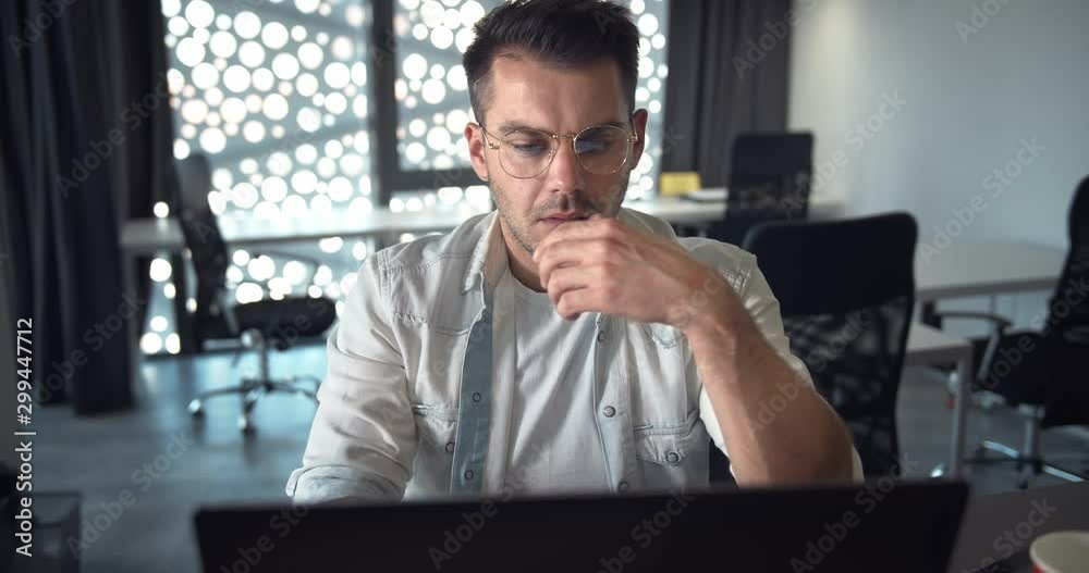 Exhausted male office worker browsing internet searching for information, deadline stress Exhausted male office worker browsing internet searching for information, deadline stress