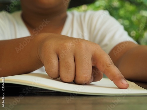 Boy finger pointing on books