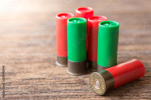 Selective focus of Many Bullet of Shotgun on wooden background with sunlight