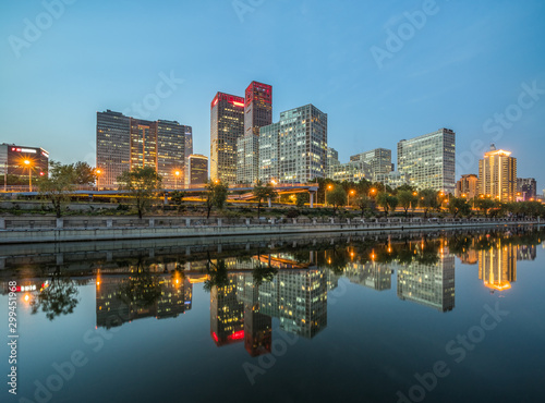 Business district office buildings and water reflection in Beijing at night