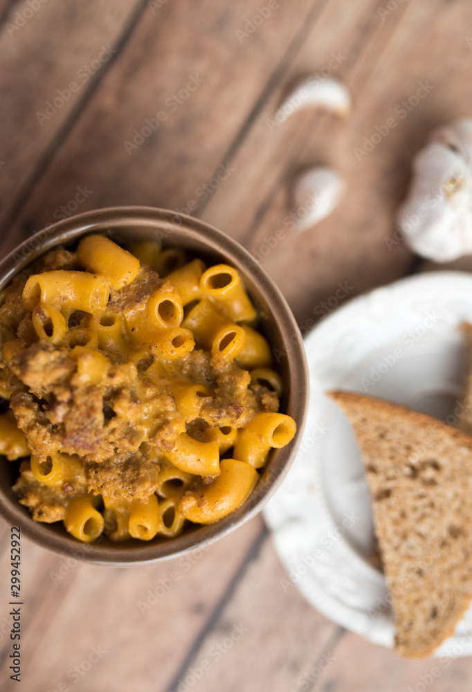 Homemade Cheeseburger Macaroni and cheese served in a small brown bowl made with ground turkey Homemade Cheeseburger Macaroni and cheese served in a small brown bowl made with ground turkey