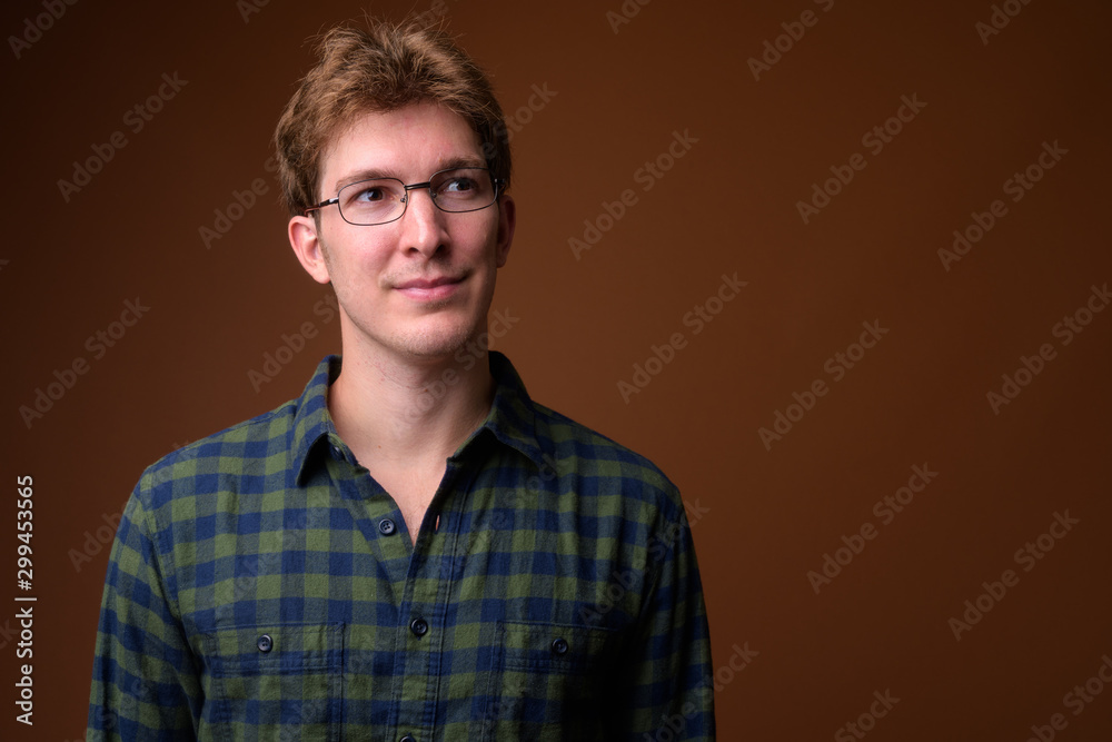 Fototapeta premium Face of young handsome hipster man with eyeglasses