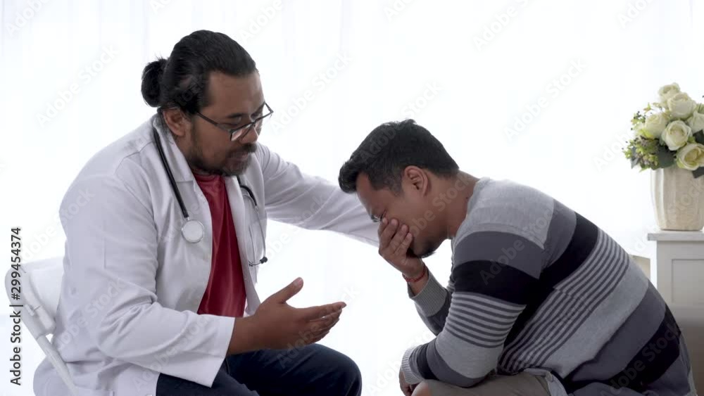 portrait of depress patient consulting with his doctor in his office portrait of depress patient consulting with his doctor in his office