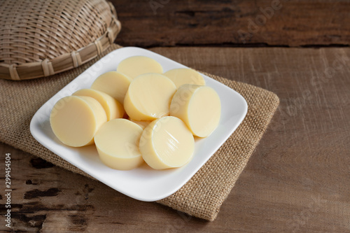 sliced of egg tofu in a ceramic dish on wooden table prepare to cook, close up. healthy food concept.