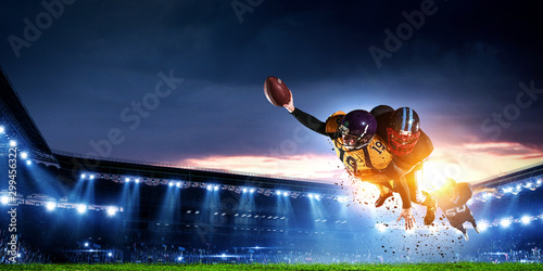 American football players fight for ball. Mixed media