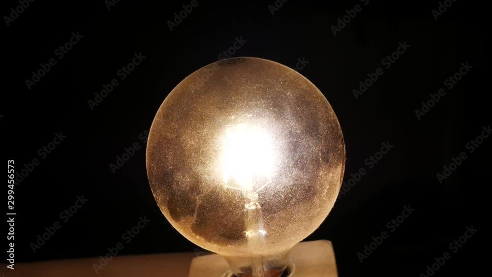 Retro style incandescent lightbulb, zooming in Retro style incandescent lightbulb, zooming in