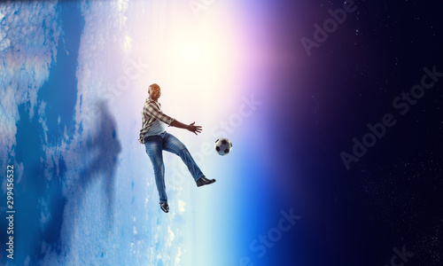 Soccer man in action with ball. Mixed media