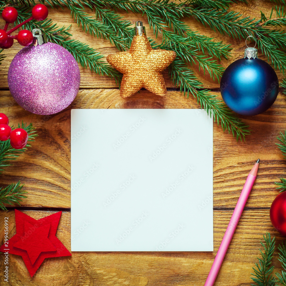 Obraz premium Christmas tree with decoration on a wooden board. Christmas toy. New year. Sheet for congratulations.