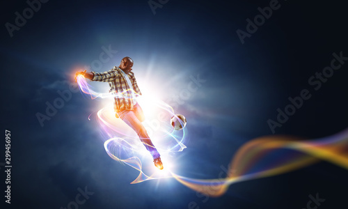 Soccer man in action with ball. Mixed media