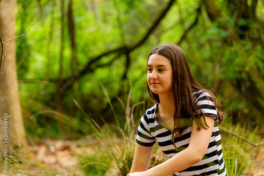 Young woman walking in parkland Young woman walking in parkland