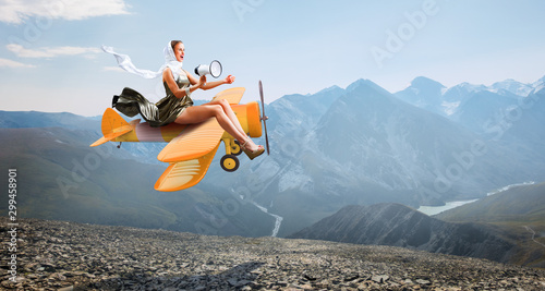 Photos Woman in retro airplane . Mixed media