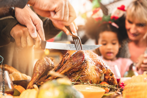 Thanksgiving Celebration Tradition Family Dinner Concept.family having holiday dinner and cutting turkey.Young black adult woman and her daughter happy.. photo