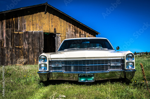 Lowered car in field with barn near elizabeth colorado photo