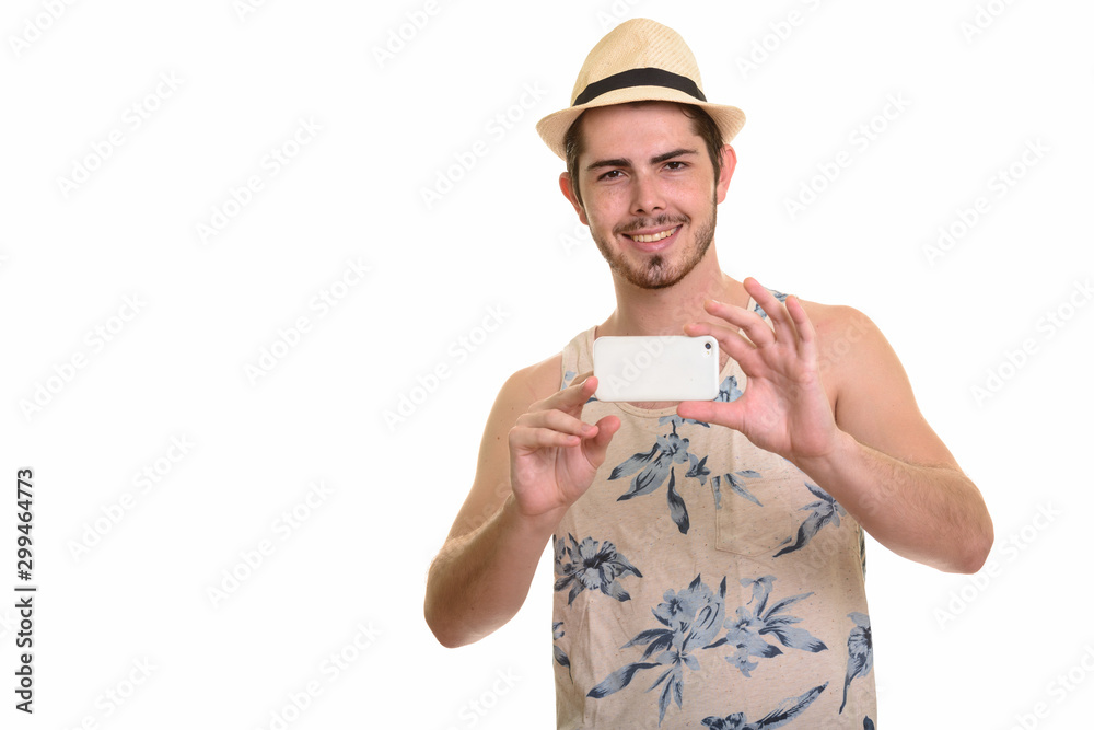 Happy young bearded tourist man taking picture with phone ready for vacation Happy young bearded tourist man taking picture with phone ready for vacation