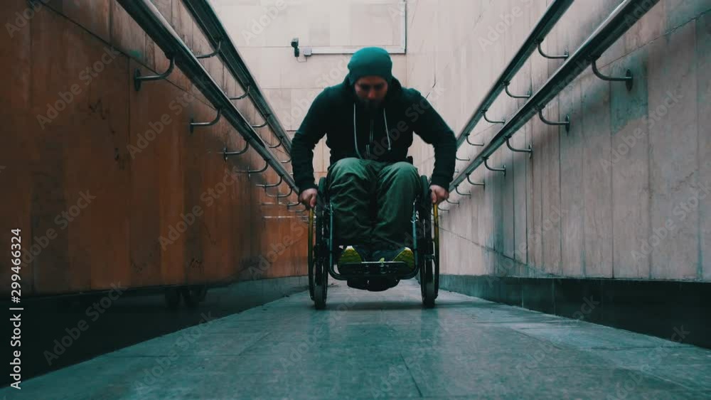 Dozing On A Ramp Disabled man in wheelchair getting up on the long special ramp ...