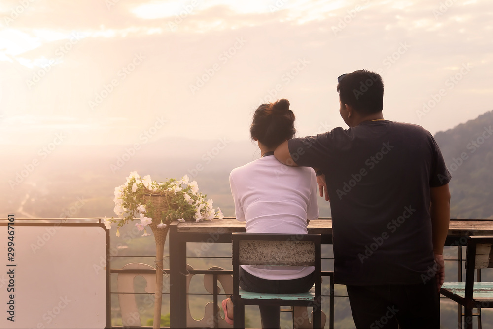 Asian couples are watching the beautiful sunset on the mountains at petchabun province , Thailand. Asian couples are watching the beautiful sunset on the mountains at petchabun province , Thailand.