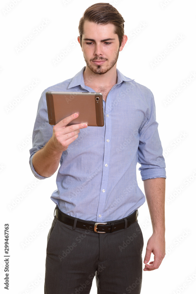 Portrait of young handsome bearded businessman using digital tablet Portrait of young handsome bearded businessman using digital tablet