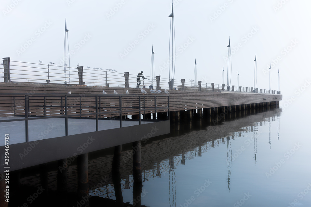 Sea pier in foggy weather