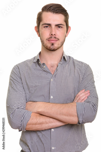 Portrait of young handsome bearded businessman looking at camera