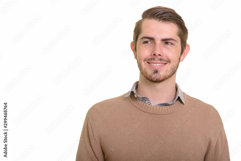 Portrait of happy young handsome bearded man
