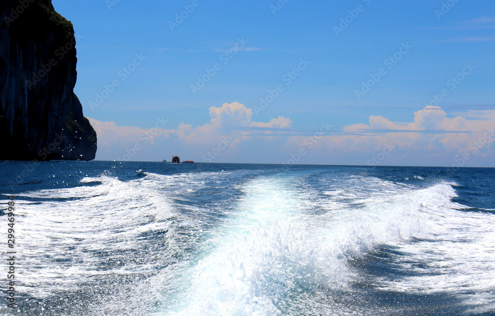 boat ride on the sea, exotic James Bond islands against the blue sea, waves of spray in Thailand boat ride on the sea, exotic James Bond islands against the blue sea, waves of spray in Thailand