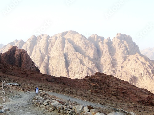 Tourists are hiking in the Mount Sinai, which is a mountain in the Sinai Peninsula of Egypt, for its famous sunset and sunrise scenery. Mount Sinai is considered a holy site by the Abrahamic religions