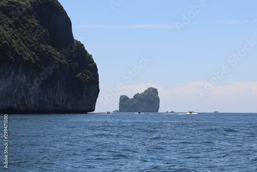 boat ride on the sea, exotic James Bond islands against the blue sea, waves of spray in Thailand