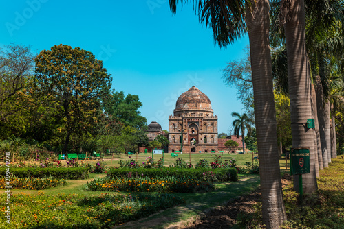 A view of the Lodhi garden with palm trees and ancient tomb, a famous tourist place in Delhi, India.