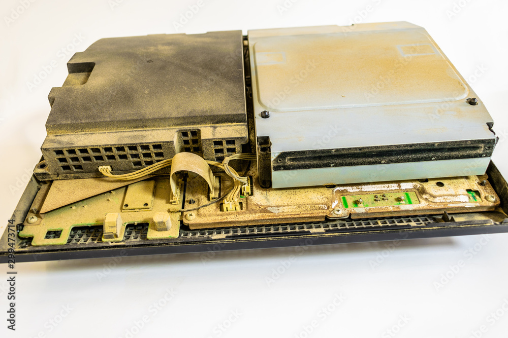 closeup of an old and dirty dusty game console with white background and lots of dust on it closeup of an old and dirty dusty game console with white background and lots of dust on it