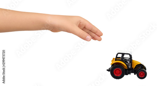 Yellow plastic traktor toy. Farming vehicle, harvest equipment.
