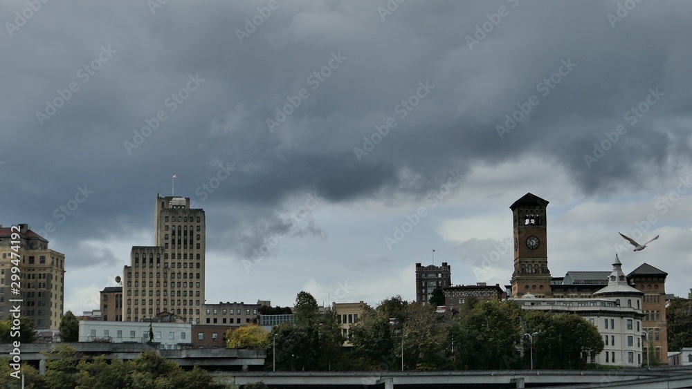 cityscape of an old town with stormy clouds above