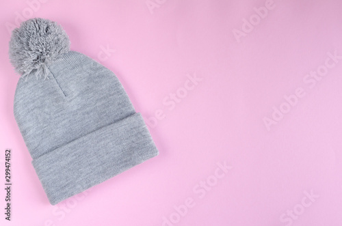 Gray cotton hat composition on pink background. Flat lay.