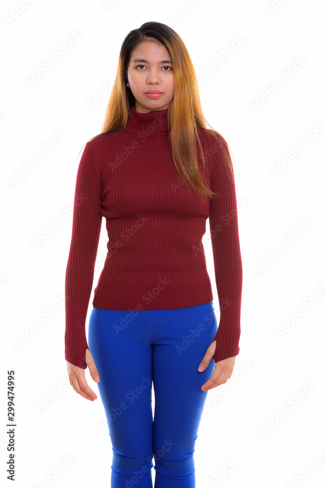 Studio shot of young Asian woman with turtleneck sweater Studio shot of young Asian woman with turtleneck sweater