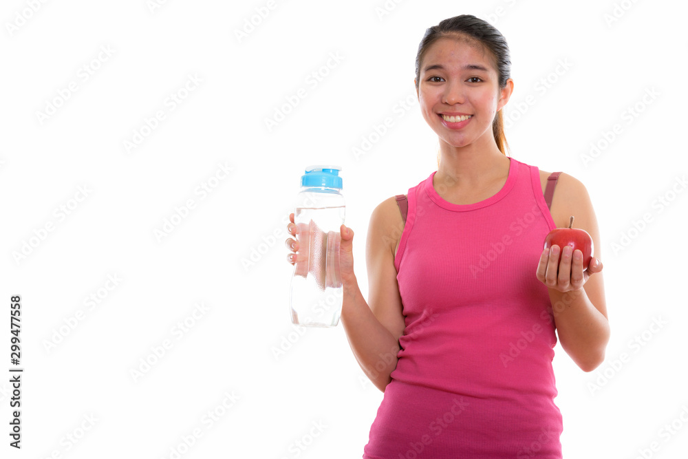 Studio shot of young Asian woman ready for gym Studio shot of young Asian woman ready for gym
