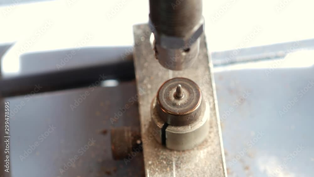 Leather worker using press for installing metal rivet on geniune leather product. Using rivet gun during work with leather. Close up 4k